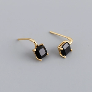 Close-up of gold S925 silver stud earrings featuring square-cut black zircon stones