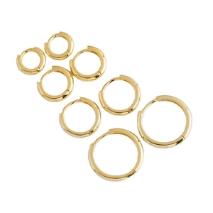 Set of 4 pairs golden 925 sterling silver hoop earrings in varying sizes on white backdrop