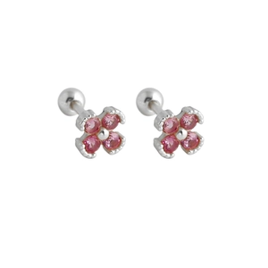 Macro shot of 925 sterling silver flower earrings with pink zircons and screw backs