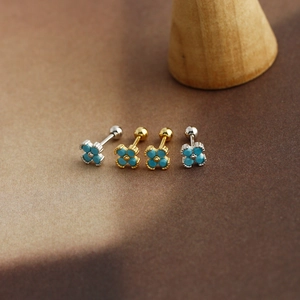 Macro view of flower stud earrings with blue turquoise petals and screw ball backing