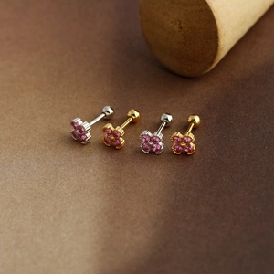 Detailed macro view of S925 sterling silver flower earrings with pink gems and screw backs