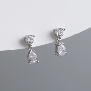 Detailed close-up of S925 silver stud earrings with pear-cut teardrop cubic zirconia