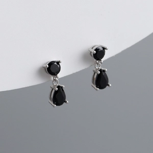 Detailed macro shot of S925 silver stud earrings with black pear-cut cubic zirconia