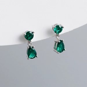 Close-up of S925 sterling silver stud earrings with emerald pear-cut zircon drops