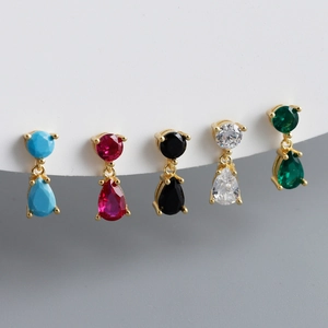 Macro shot of 5 colorful teardrop zircon studs with gold plating and prong setting