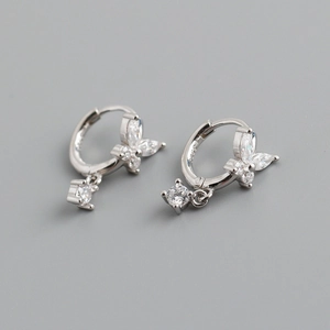 Macro shot of S925 silver mark on gold butterfly hoop earrings with sparkling crystals