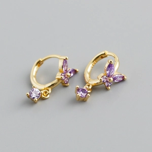 Close-up of golden butterfly earrings with purple zircon stones and S925 silver stamp