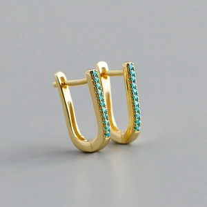 Detail of U-shaped gold earrings with inlaid turquoise stones and S925 silver base