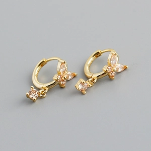 Detail of S925 hallmark on gold butterfly hoop earring with champagne zircon stones