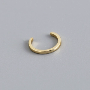 Close-up of minimalist gold-plated S925 sterling silver ear cuff with a polished finish