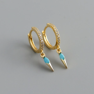 Macro shot of gold hoop earrings with inlaid marquise turquoise and white zircon accents