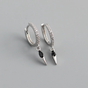Macro detail of silver hoop earrings with black marquise stone and zircon pavé