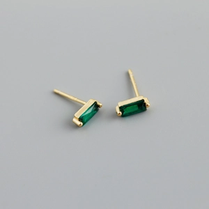 Macro detail of square green zircon stones set in gold plated S925 silver stud earrings