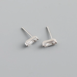 Detailed macro shot of rectangular zircon stud earrings with S925 silver hallmarks