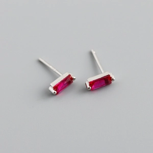 Close-up of minimalist S925 silver stud earrings with rectangle red zircon inlay