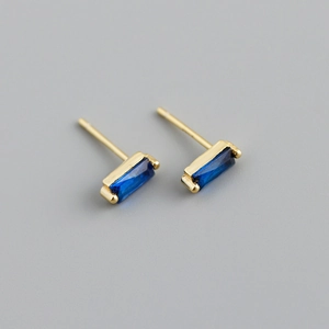 Close-up of rectangular blue zircon earrings with polished gold-plated S925 silver settings