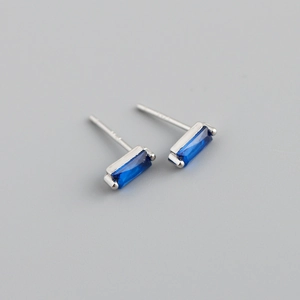 Detailed macro view of square cut deep blue zircon earrings with silver prong setting