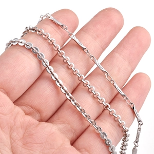 Three styles of minimalist stainless steel chains including flat disc and classic link types
