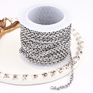 Polished stainless steel Boston chain roll on a white spool for DIY jewelry making
