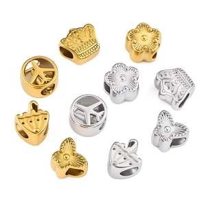Gold and silver DIY jewelry charms in airplane, butterfly, and crown shapes