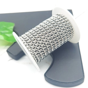 Silver stainless steel curb chain spool for DIY jewelry making on marble surface