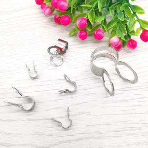 Macro view of various sizes silver stainless steel pinch bails for DIY jewelry making
