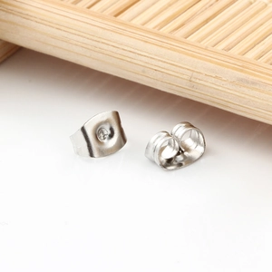 Polished stainless steel butterfly earring backs pair on minimalist white background