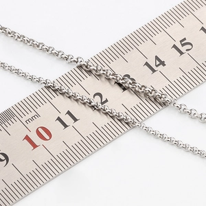 Polished stainless steel link chain with a 2mm diameter measured on a scale ruler