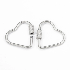 Detail of silver heart-shaped screw lock carabiner showing open and closed mechanisms