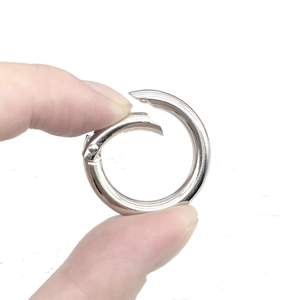 Polished silver alloy spring O-ring clasp for bags and keychains shown in hand