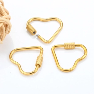 Close-up of golden heart-shaped screw locks with anti-slip texture for DIY jewelry making