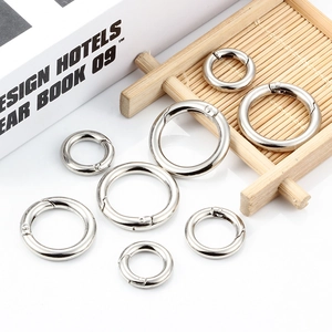 Detailed view of various sizes of silver metal O-ring spring buckles for bags and keychains
