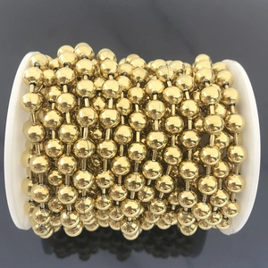 Close-up of 6mm golden stainless steel ball chain wound on white plastic spool