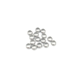 Macro shot of stainless steel crimp beads for DIY jewelry making with smooth silver finish