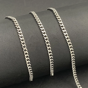 Polished stainless steel flat curb chain for DIY jewelry making on dark leather roll