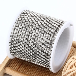 Detail of 3mm sparkling rhinestone claw chain on a spool for DIY jewelry making and crafts