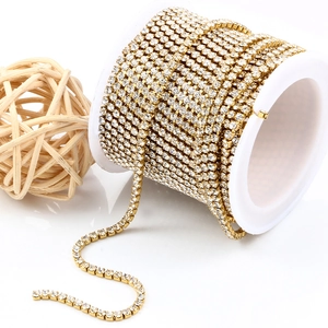 Golden 3mm rhinestone claw chain on white spool for DIY jewelry making and crafts