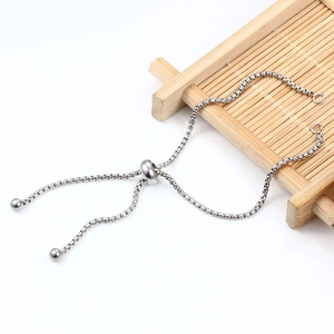 Verstelbare zilveren boxketting armband met schuifsluiting gepresenteerd op bamboe