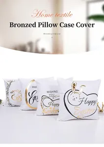 Detail of four white Easter pillow covers with gold and black foil festive prints