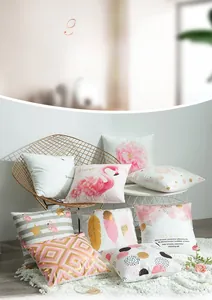Luxe gold foil cushion covers with flamingo and feather patterns on a metal chair