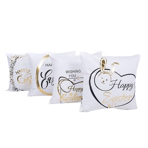 Set of four white Easter pillow covers with golden bunny patterns and Happy Easter text