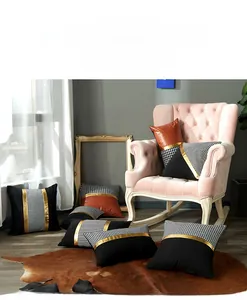 Close-up of modern luxury cushion cover with houndstooth and gold leather splicing