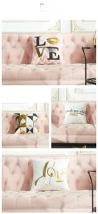 Detail view of modern laser bronzed cushion covers with love patterns on a pink sofa