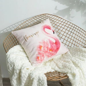 Pink flamingo pillow case with gold lettering on a white fur rug and gold chair