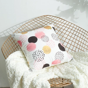 Modern white pillow cover with gold and pink laser foil dots on metal chair