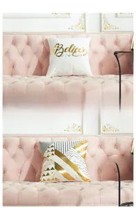 Detail of modern laser bronzing cushion covers with geometric patterns and gold lettering