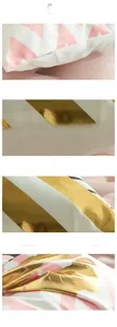 Detail of hidden zipper and laser bronzing gold leaf pattern on pink cushion cover