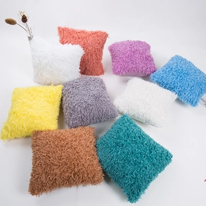 Fundas de cojín cuadradas de piel sintética de colores dispuestas en abanico blanco