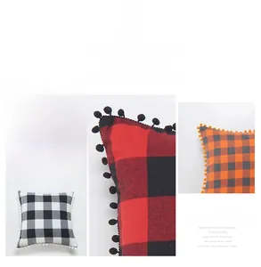 Detail of plaid cushion covers with decorative pom-pom trim in modern color schemes
