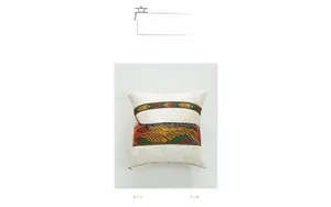 Close-up of bohemian style woven ribbons and hidden zipper on white velvet pillow cover